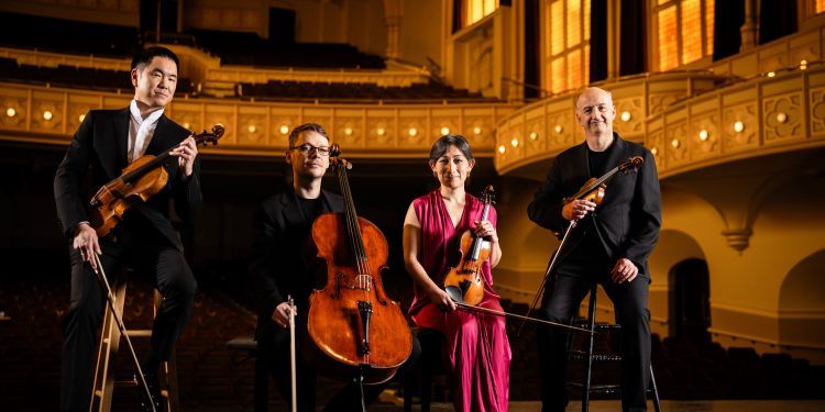The Takacs Quartet sat on stage in an empty concert hall