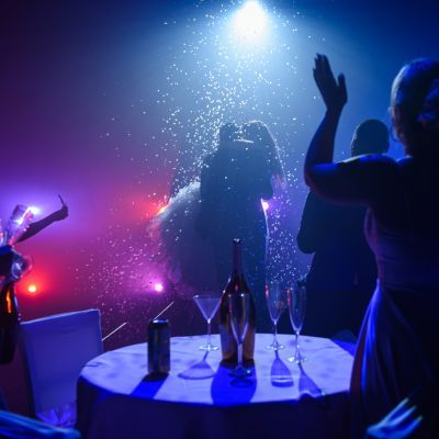 A couple embrace and onlookers cheering.