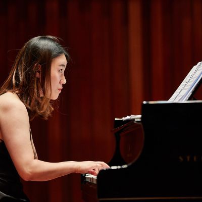 Student pianist on stage performing