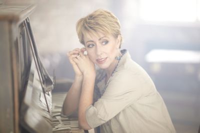 Nikki Iles sat down with elbows resting on a piano