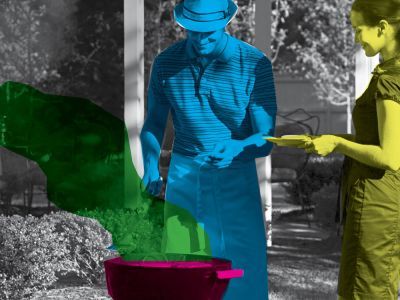 A blue man and yellow woman stand over a pink cauldron. The rest of the background is black and white. 