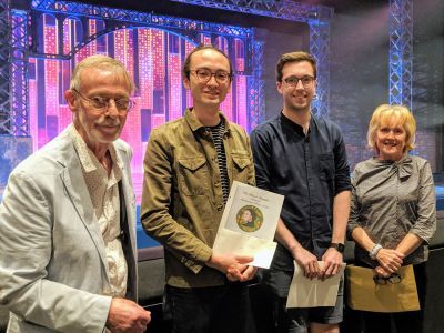 image of four people holding certificates