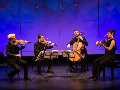 four people playing musical instruments