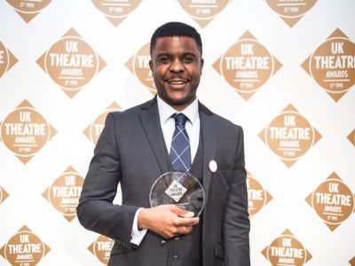 Ashley Zhangazha holding his award