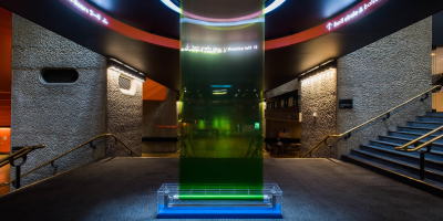 An installation made of glass, water and green paint, situated in the Barbican's foyer