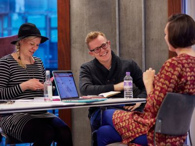 students sat at table in meeting