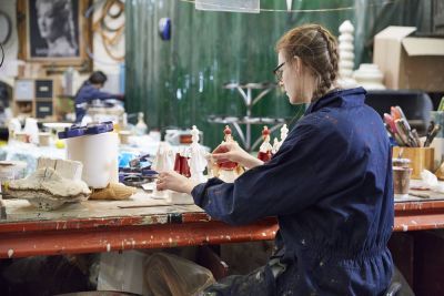 Production Arts student painting at bench