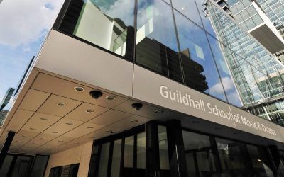 A close up image of Milton Court with the words Guildhall School of Music & Drama