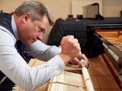 man tuning a piano