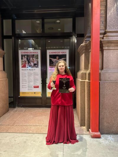 Olivia outside Carnegie Hall with her prize
