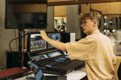 Student in a studio with technical equipment