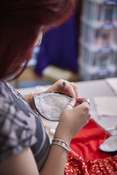 Person sewing a piece of cloth