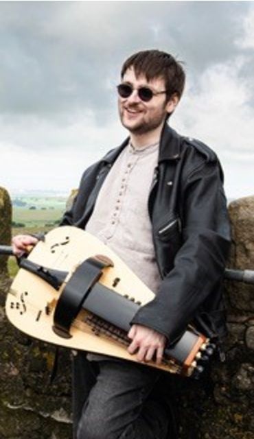 Oliver Cross playing a hurdy gurdy