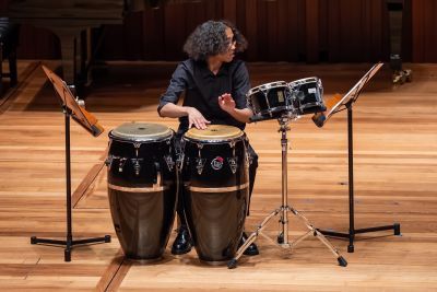 Yuma Angius-Thomas playing bongos
