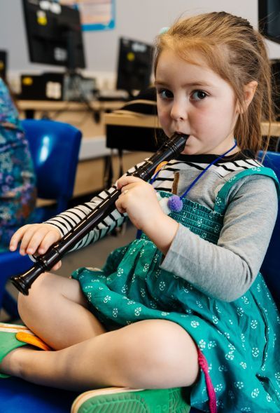 Young girl playing the recorder