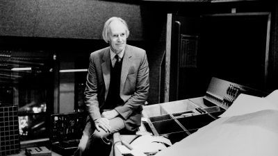 Man sitting in recording studio in a suit 
