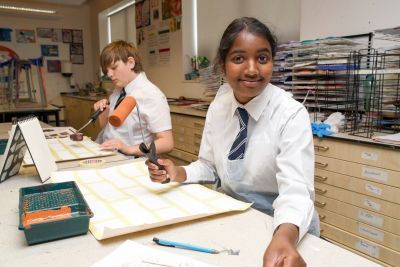 School pupils work on their scenic art canvases