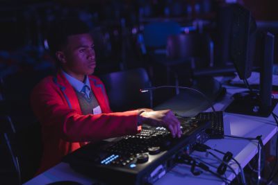School pupil operates a theatre lighting desk