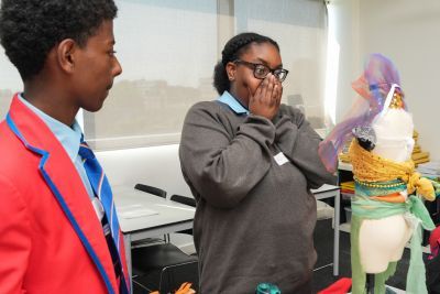 School pupils proudly look at their costume creation