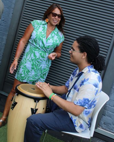 Nikki Yeoh and MEI student playing drum